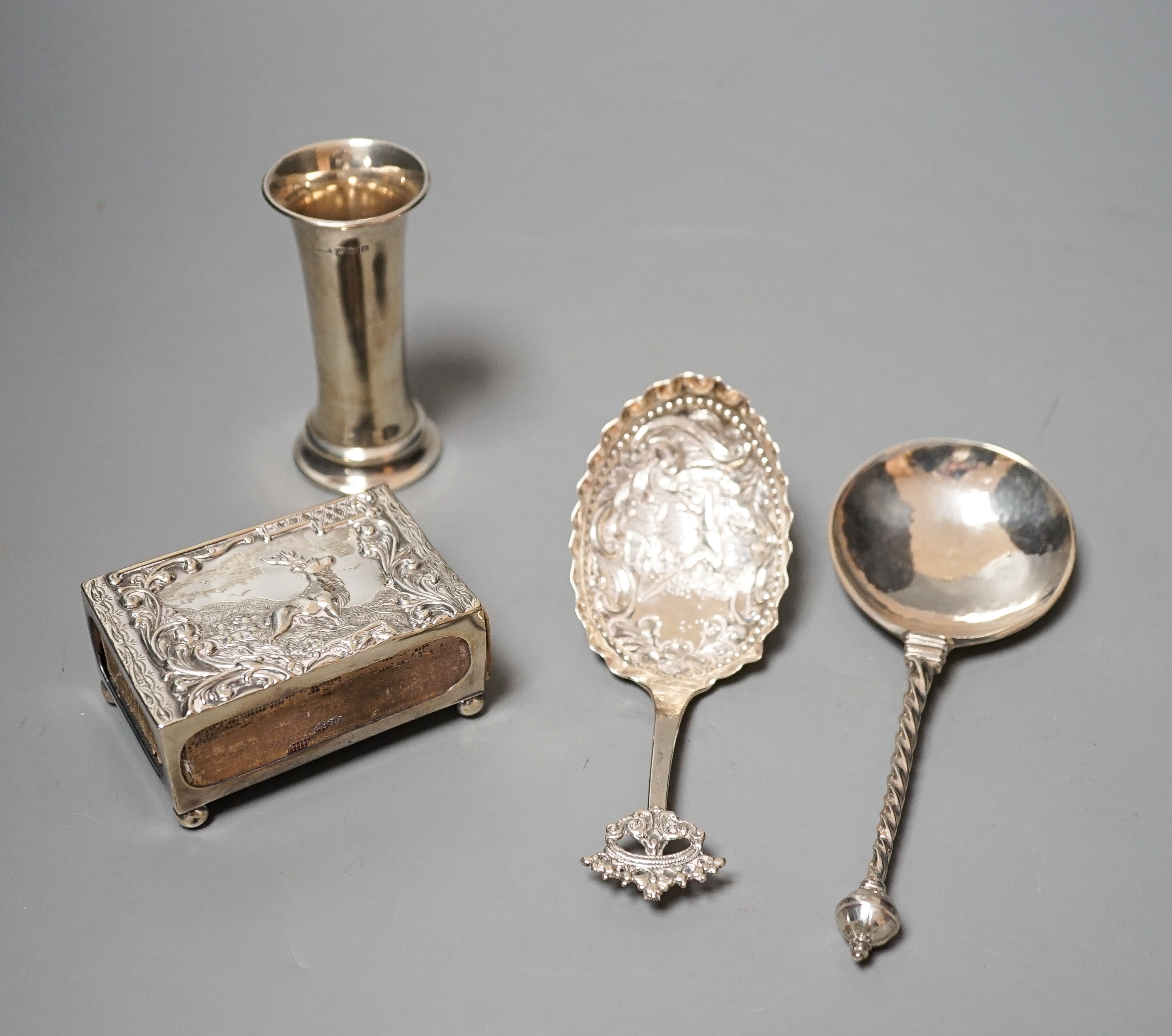 A 19th century Dutch embossed white metal spoon, 13.5cm, one other unmarked white metal spoon, a small silver posy vase and a repousse silver match sleeve.